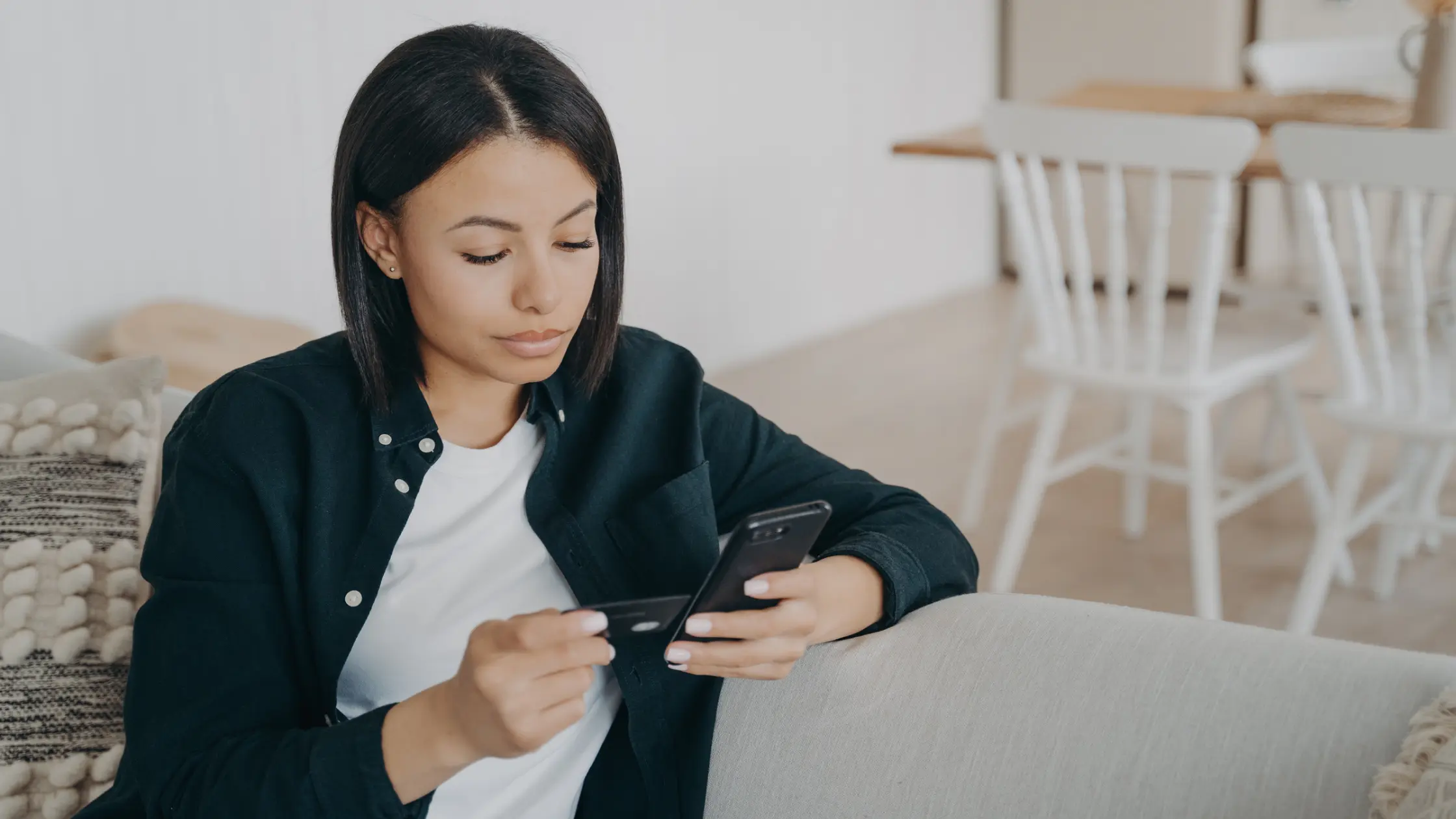 A short-haired woman reviewing Royal Invest's online rent collection page